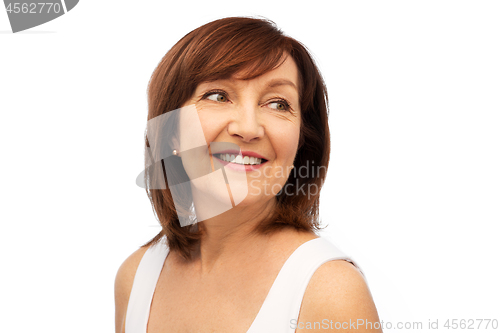 Image of portrait of smiling senior woman over white