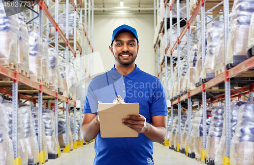 Image of indian delivery man with clipboard at warehouse