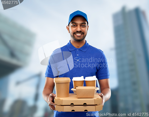 Image of happy indian delivery man with food and drinks