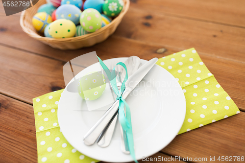 Image of close up of table setting and easter eggs