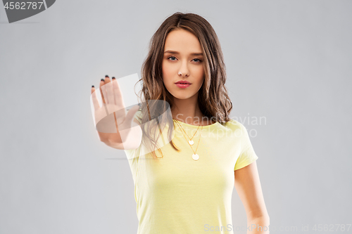 Image of young woman or teenage girl showing stop gesture