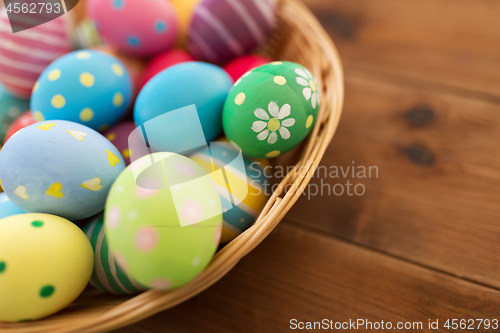 Image of close up of colored easter eggs in basket