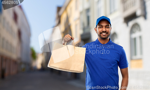 Image of indian delivery man with food in paper bag in city