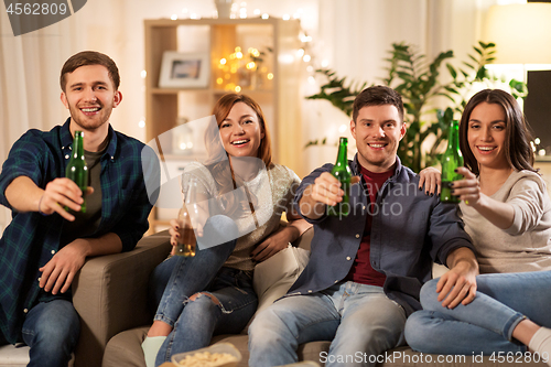 Image of friends toasting non-alcoholic beer at home