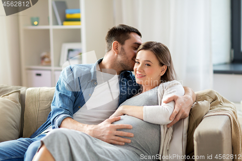 Image of man hugging pregnant woman at home