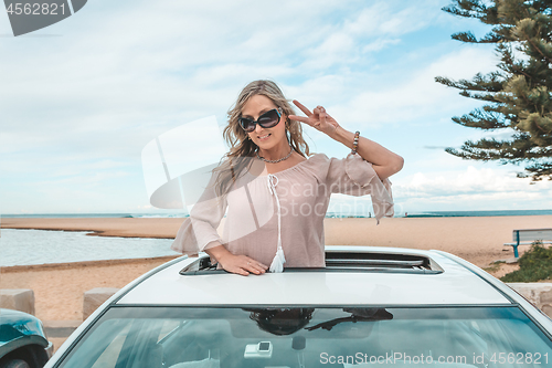 Image of Fun woman enjoy travelling in her car