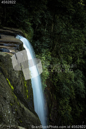 Image of Cascading waters flow off tall cliffs 