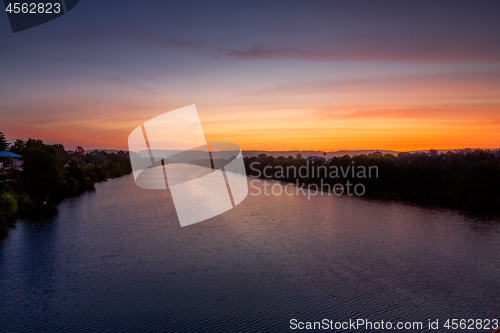 Image of Nepean River glowing with reds and blues at sunset