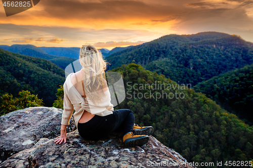 Image of Woman mountain gazing at sunset