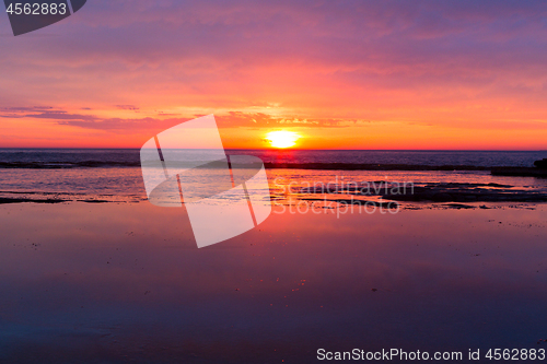Image of Coastal sunrises as daybreaks turning skies red, orange, pink and yellow