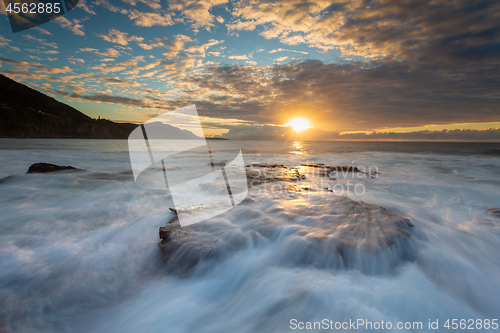 Image of Tidal waves cascading over the rocky coastline at Coalcliff Aust