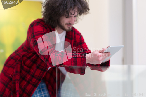 Image of young freelancer using tablet computer