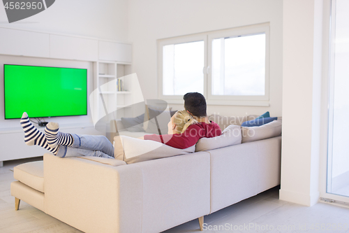 Image of Young couple on the sofa watching television