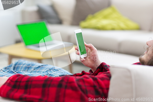 Image of young man in bathrobe enjoying free time