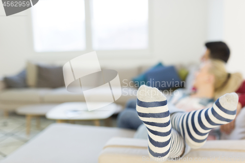 Image of couple hugging and relaxing on sofa