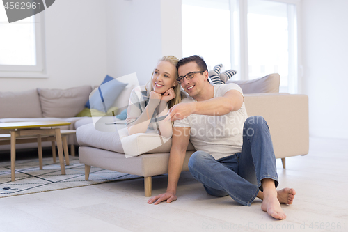 Image of Young couple on the sofa watching television