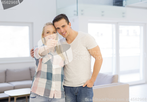 Image of couple showing a keys of their new house