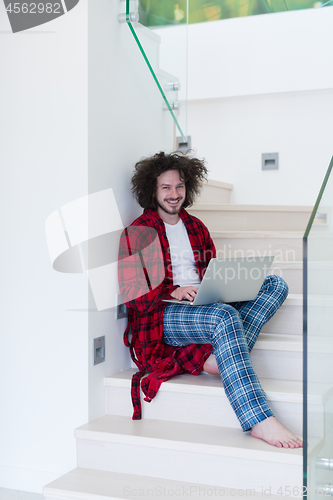 Image of freelancer in bathrobe working from home