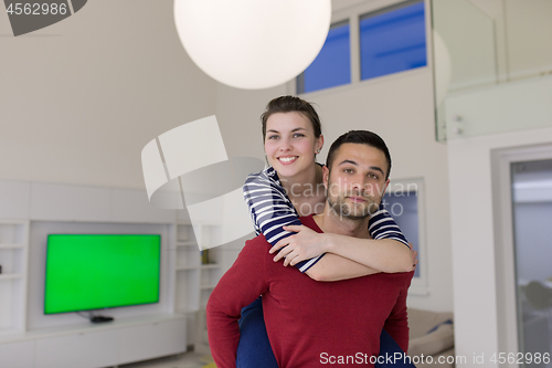 Image of handsome man piggybacking his girlfriend