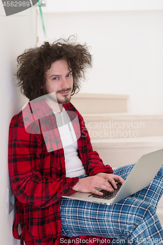 Image of freelancer in bathrobe working from home