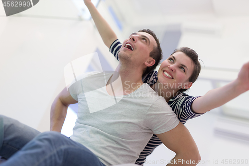 Image of handsome man piggybacking his girlfriend