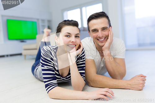 Image of couple lying on the floor at home
