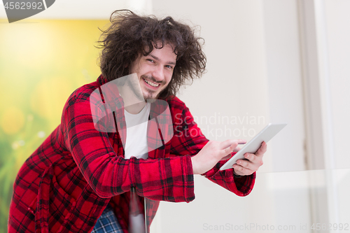 Image of young freelancer using tablet computer