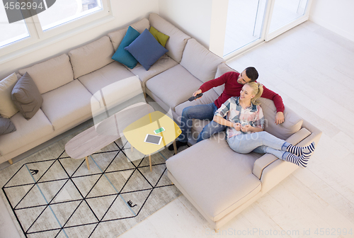 Image of Young couple on the sofa watching television