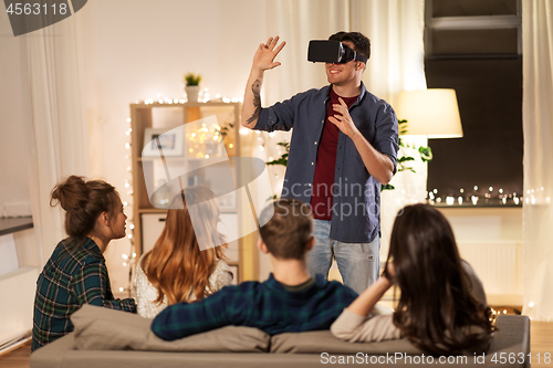 Image of man in vr glasses at home with friends