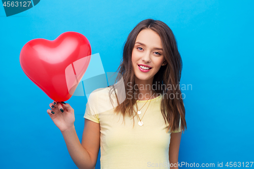 Image of teenage girl with red heart-shaped balloon