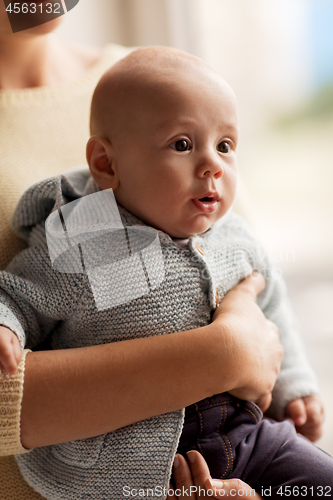 Image of close up of mother with little baby in cardigan