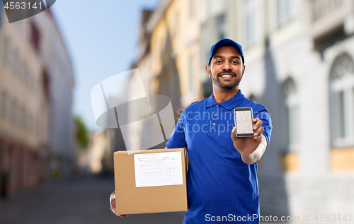 Image of delivery man with smartphone and parcel in city