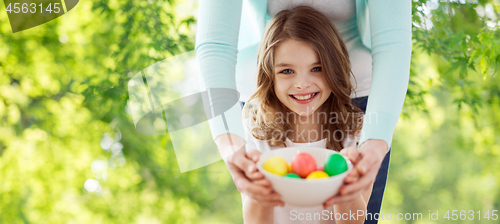 Image of happy smiling girl and mother with easter eggs