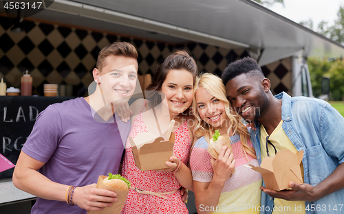 Image of happy friends with wok and burger at food truck