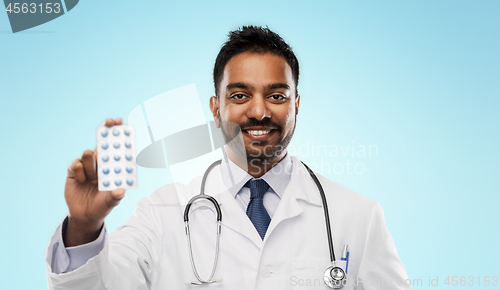 Image of indian male doctor with pills and stethoscope