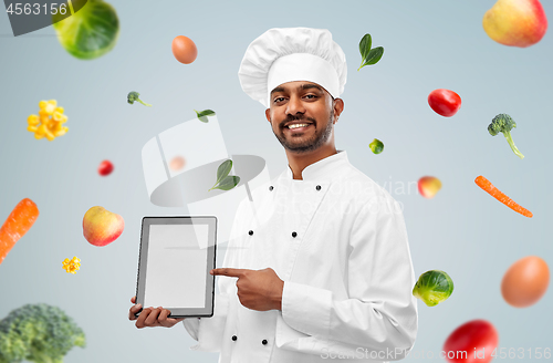 Image of happy male indian chef with tablet computer