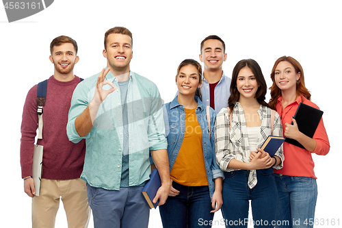Image of group of smiling students showing ok hand sign