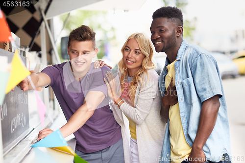 Image of happy customers or friends at food truck