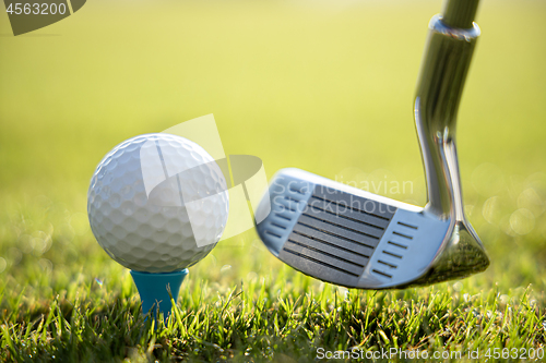 Image of Golf ball on tee in front of driver