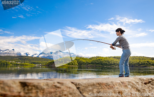 Image of Woman fishing on Fishing rod spinning in Norway.