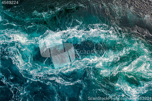 Image of Waves of water of the river and the sea meet each other during h