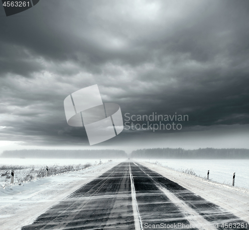 Image of Stormy sky and snow road