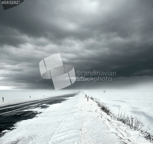 Image of Stormy sky and snow road