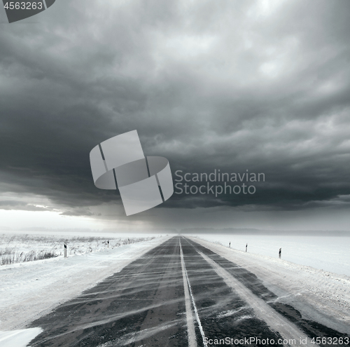 Image of Stormy sky and snow road