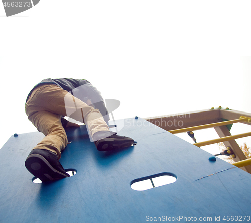 Image of Boy climbs to the top