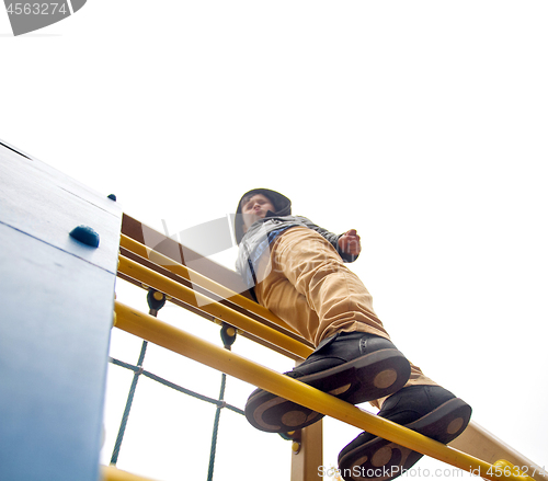 Image of Boy climbs to the top