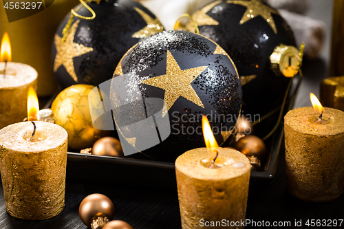 Image of Christmas still life with ornaments and candles