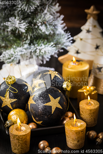 Image of Christmas still life with ornaments and candles