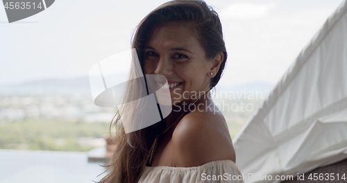 Image of Happy tourist on terrace at resort in sunny day