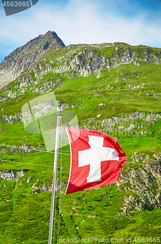 Image of The Swiss flag is blowing in the wind